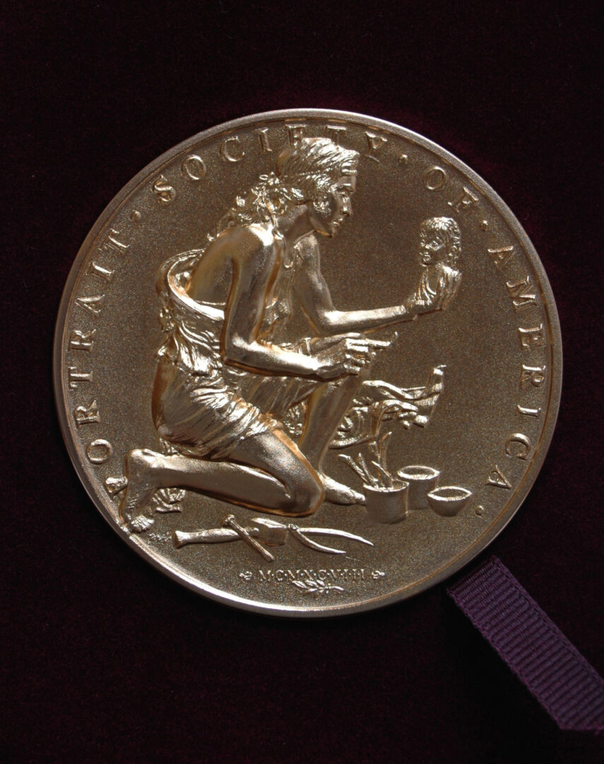 A gold medal with a man on it