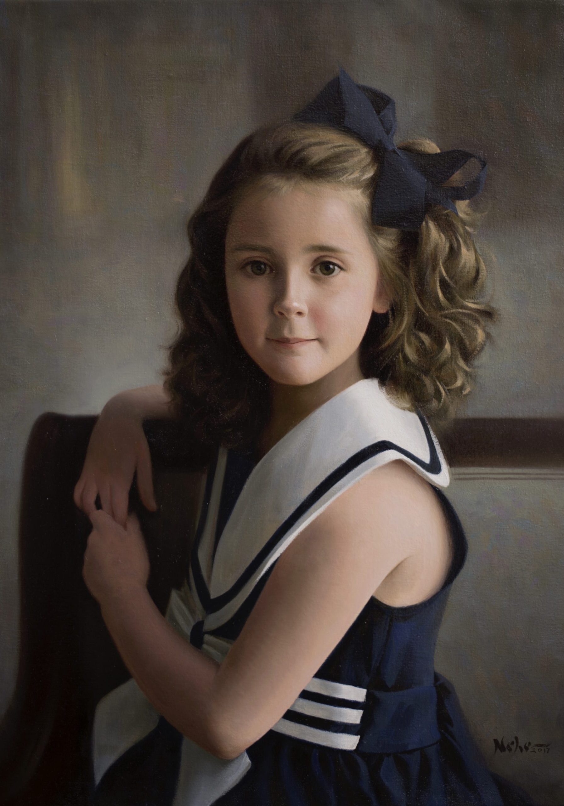 A young girl with long hair and a bow in her hair.